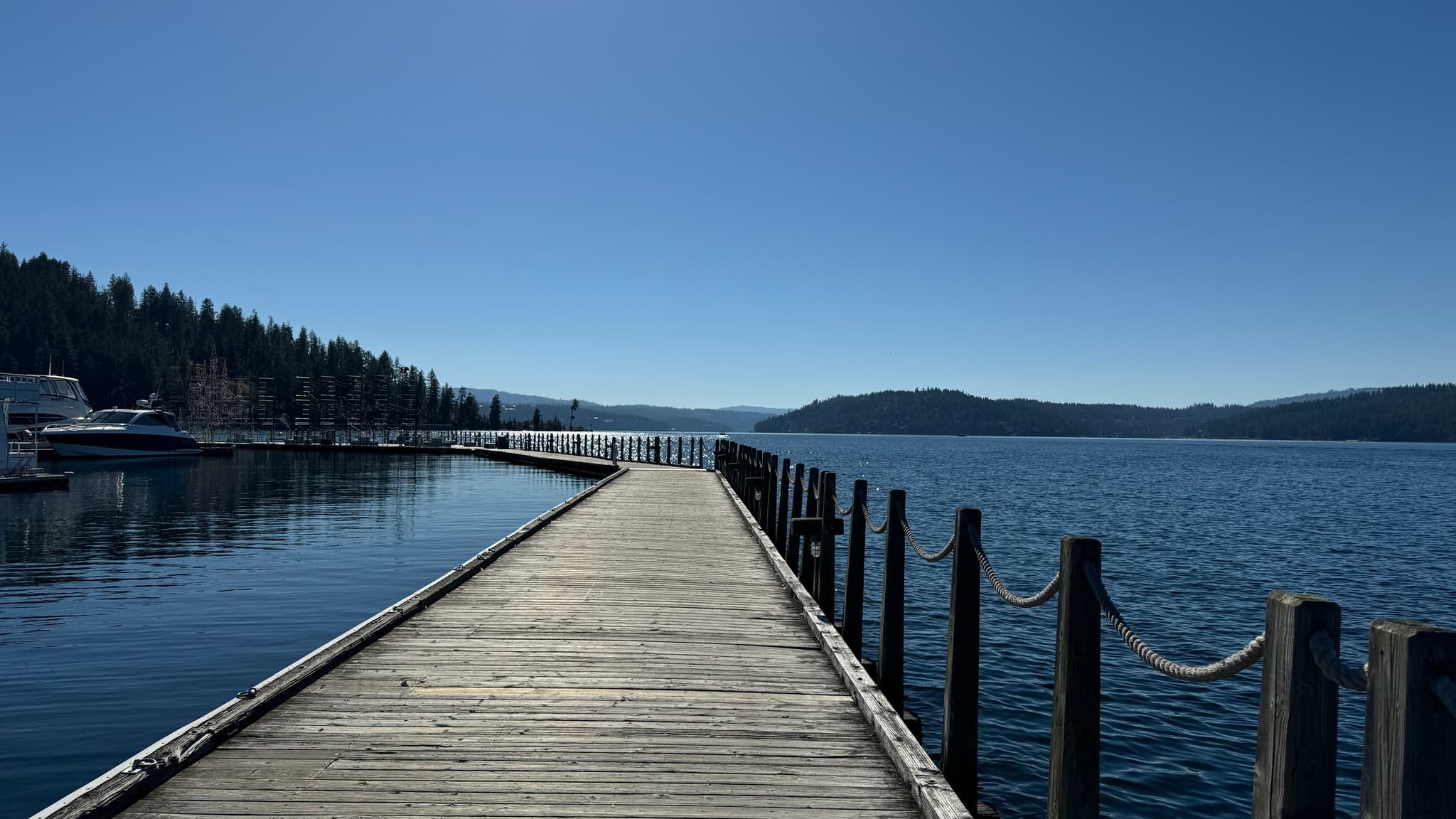 Calm Northern Idaho lake with forested mountain backdrop